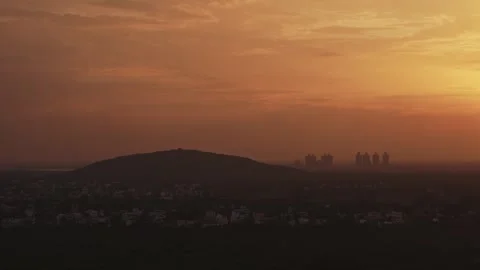 Aerial drone shot of sunset over hill and town skyline in Theni, Tamil Nadu Stock Footage 341053507