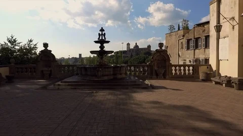 Aerial drone shot through ancient fountain up city panorama Viterbo Stock Footage 125496046
