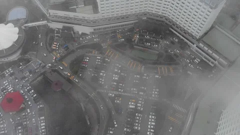 Aerial drone shot through clouds to reveal cars driving around winding roads Video stock 91119885