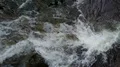 Aerial drone shot top view close up water streaming over waterfall rocks 4k or 4k+ Resolution