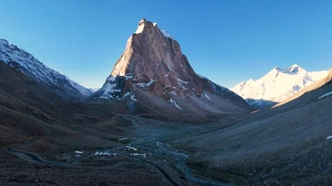 Aerial drone shot tracking the changing colors on Gumbok Rangan as morning light Stock Footage 310752226