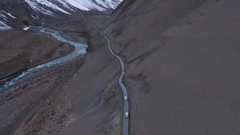 Aerial drone shot tracking the path of a lone vehicle in Spiti, moving along a Video stock 304951035
