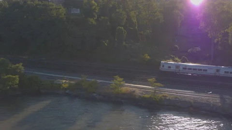 Aerial Drone Shot Tracking Train Leaving New York City Along Hudson River Video stock 143208708