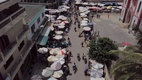 Aerial drone shot travelling along street of city market in Togo Africa Stock Footage
