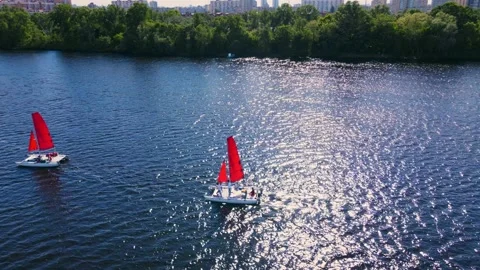 Aerial drone shot two catamarans sailing the blue sea.  Stock Footage 201518058