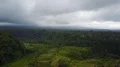 Aerial drone shot valley rice fields cloudy mountain forest landscape Indonesia 4k or 4k+ Resolution