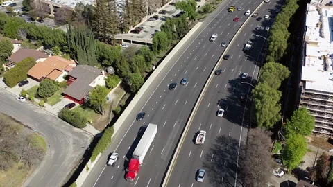 Aerial: Drone shot of vehicles on elevated road amidst buildings in city during Stock Footage 129066500