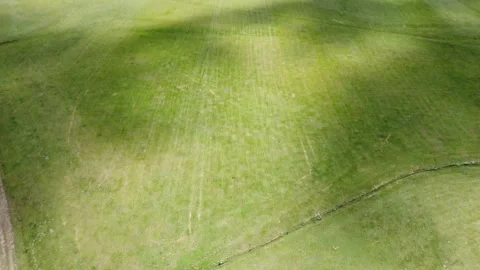 Aerial drone shot of a verdant plain with majestic hills in the background Stock Footage 218608741