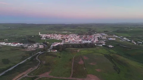 Aerial drone shot of Vila do Bispo, Portugal at sunset with push in Stock Footage 338126409