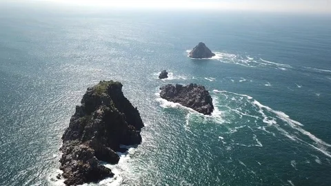 Aerial drone shot. Waves hitting rocks on the beach with sea water. Stock Footage 128369630