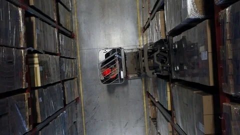 Aerial Drone Shot of Working Forklift Loader inside Logistic Warehouse. Shot in Stock Footage