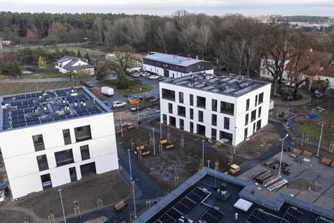 Aerial Drone Side View of Modern Housing Estate with Solar Panels Stock Photos