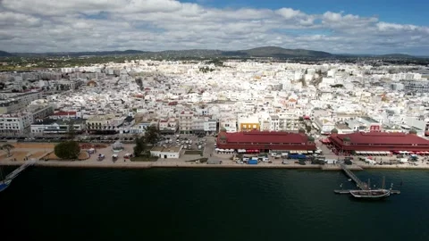 Aerial drone sideways panning showing Olhao cityscape with two market buildings Stock Footage 236375083