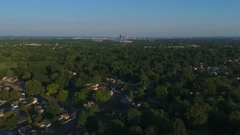 Aerial Drone Slow Float Over Rural Town towards City Skyline Stock Footage 278634637