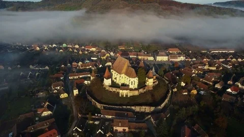 Aerial drone slow flying forward to the medieval church from a remote village. Stock Footage 78218871