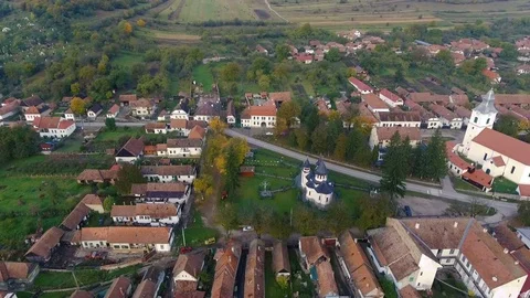 Aerial drone slow flying forward to the medieval church from a remote village. Stock Footage 78219004