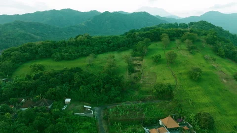 Aerial Drone Slow Pan Over Hilltop Revealing Village in Valley Stock Footage 344866435