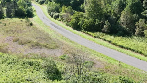 Aerial drone slow zoom in to empty country road, catskills, 4K Stock Footage 140792678