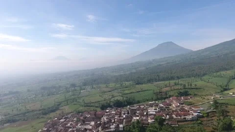 Aerial Drone Slowly Tracking in at Mountains Peaks Above Clouds and Blue Sky Stock Footage 256277352