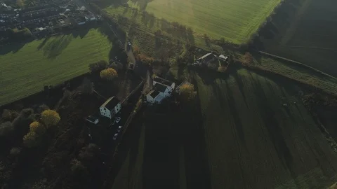 Aerial drone small road through fields with housing Video stock 122588054