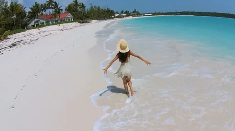 Aerial drone smiling young Asian Chinese girl on luxury resort beach Stock Footage