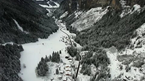 Aerial drone snow mountains range pan up village road Stock Footage 168989592