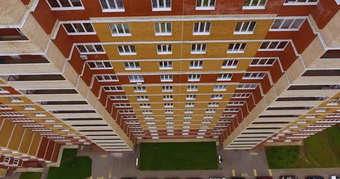 Aerial drone span in front of a brick multi-apartment residential building 스톡 동영상 169406301