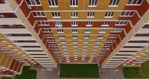 Aerial drone span in front of a brick multi-apartment residential building Vidéo 169406487