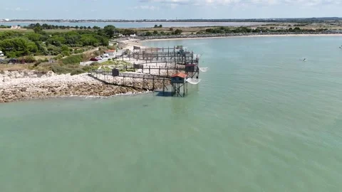 Aerial Drone Speed Forward tracking shot above wooden fishing huts on stilts Video stock 316068958
