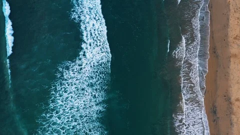 Aerial drone straight down view of medium ocean waves rolling in Stock Footage 99025405