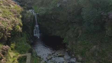 Aerial drone sun rays onto waterfall with drone flying Stock Footage 122931646