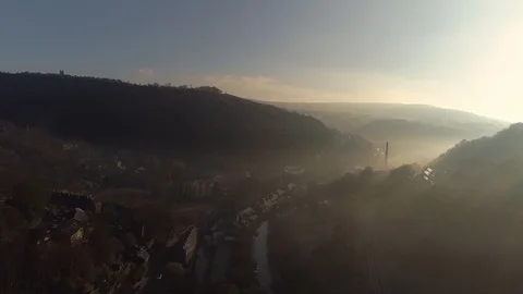 Aerial drone sunrays through fog over village Video stock 105689744