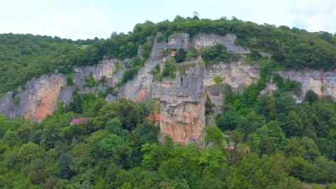 Aerial drone sweeps sideways around Katskhi Pillar in Georgia, revealing the Stock Footage 340771769