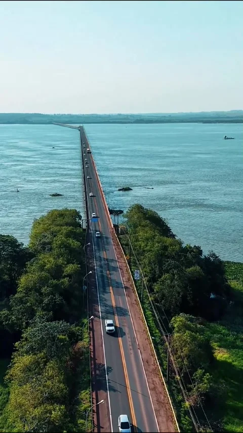 Aerial drone takeoff over long highway bridge with moving cars, 9:16 Stock-Footage 332945599