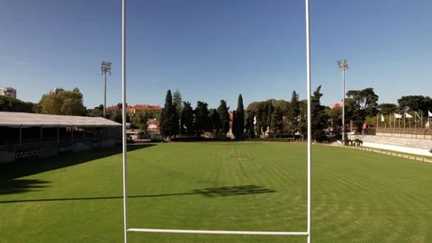 Aerial drone through goal posts on rugby pitch Stock Footage 250679467