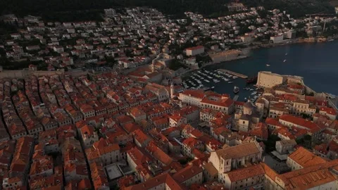 Aerial Drone Tilt Down Over Dubrovnik Old Town Terracotta Rooftops Dusk 4K Stock Footage 337850140