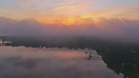 Aerial (drone) time lapse with fast moving clouds moving at sunrise Stock Footage 137604223