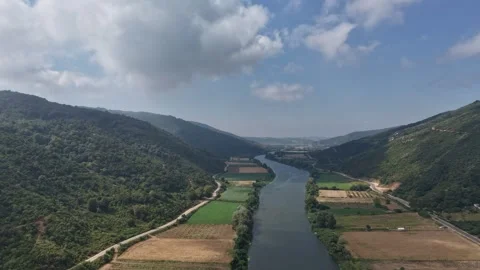 Aerial Drone Timelapse of Winding River Valley, Forest Hills and Clouds Stock Footage 341529238