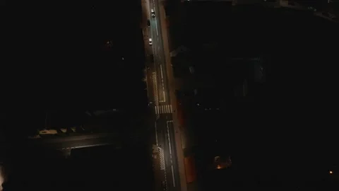 Aerial Drone Top Down Flight Over City Street at Night Stock Footage 323769900