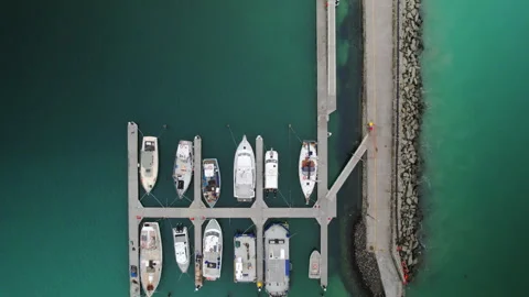 Aerial drone top down of harbour marina with boats moored at docks Vidéo 248888069