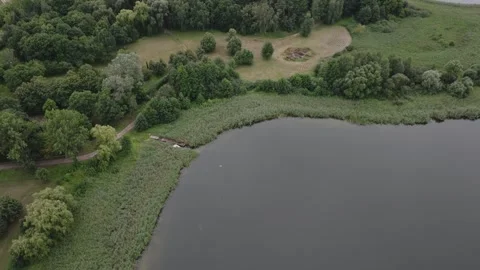 Aerial Drone Top Down to Horizon Tilt Up Over Lednica Lake Stock Footage 324976883
