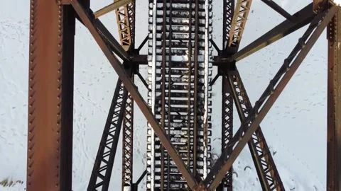 Aerial Drone Top Down Over Iron Frame Train Bridge, Winter River, Idaho Stock Footage 157134212