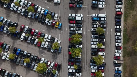 Aerial drone top down panning view of a parking lot filled with cars Video stock 321352973
