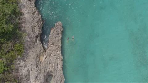 Aerial drone top down shot of two swimmers in Caribbean sea Stock Footage 137499150