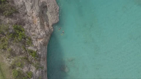 Aerial drone top down shot of two swimmers in Caribbean sea Stock Footage 137499504