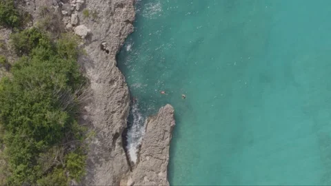 Aerial drone top down shot of two swimmers in Caribbean sea Stock Footage 137501255