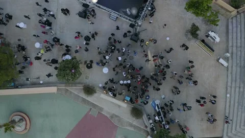 Aerial drone top down shot of gathering of people at event.  Stock Footage 143355664