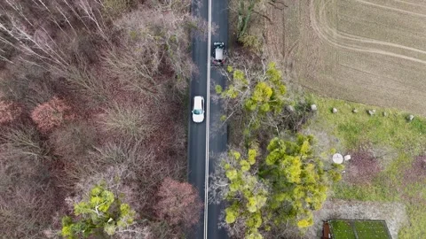 Aerial Drone Top Down Shot of Car Traffic on Forest Road Stock Footage 323874884