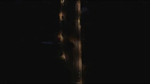 Aerial Drone Top Down Slow Forward Flight Over Illuminated Night Street Stock Footage 323769888