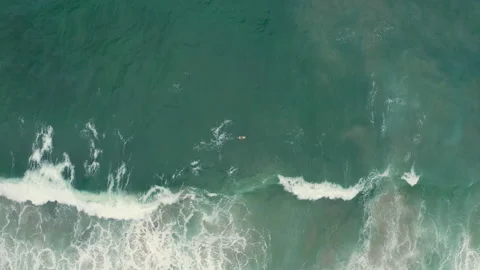 Aerial drone top down of surfer in tropical sea waves zoom in BR UBA 0752 B GR Stock Footage 143286364